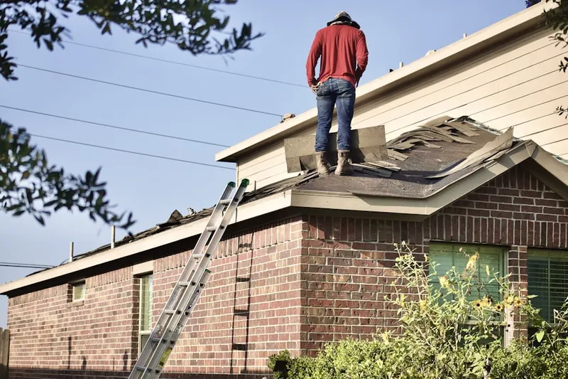 Professional roofer working on a residential roof in Winthrop Village